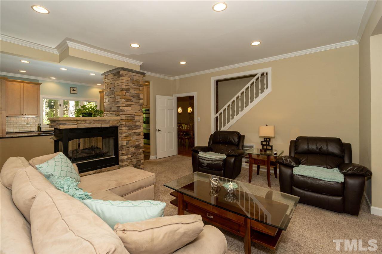 712 Misty Isle Place Raleigh, NC 27615 - Photo 13 of 30 a living room with furniture and a fireplace
