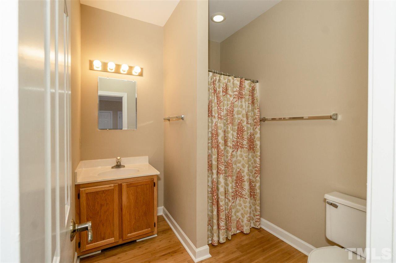 712 Misty Isle Place Raleigh, NC 27615 - Photo 14 of 30 a bathroom with a sink a toilet and shower