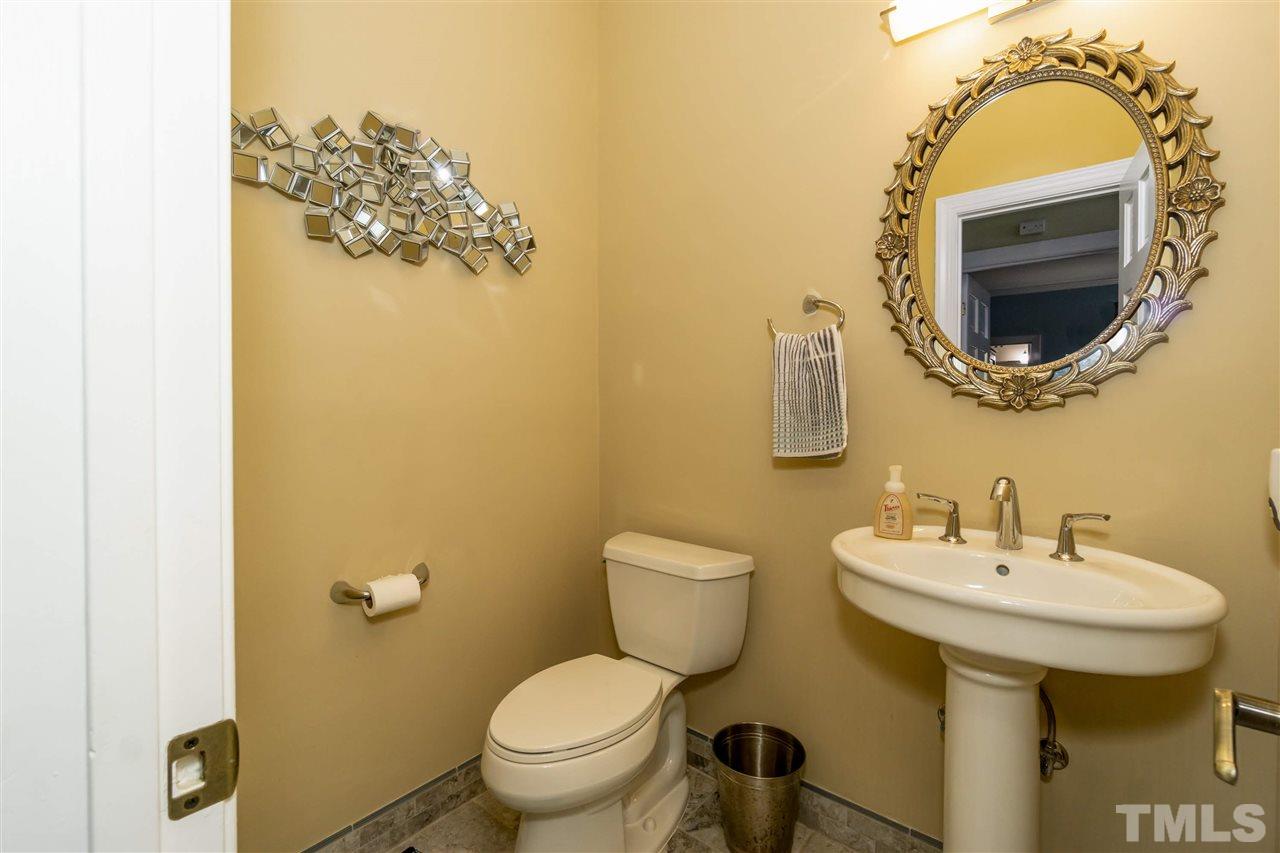 712 Misty Isle Place Raleigh, NC 27615 - Photo 16 of 30 a bathroom with a toilet sink and mirror