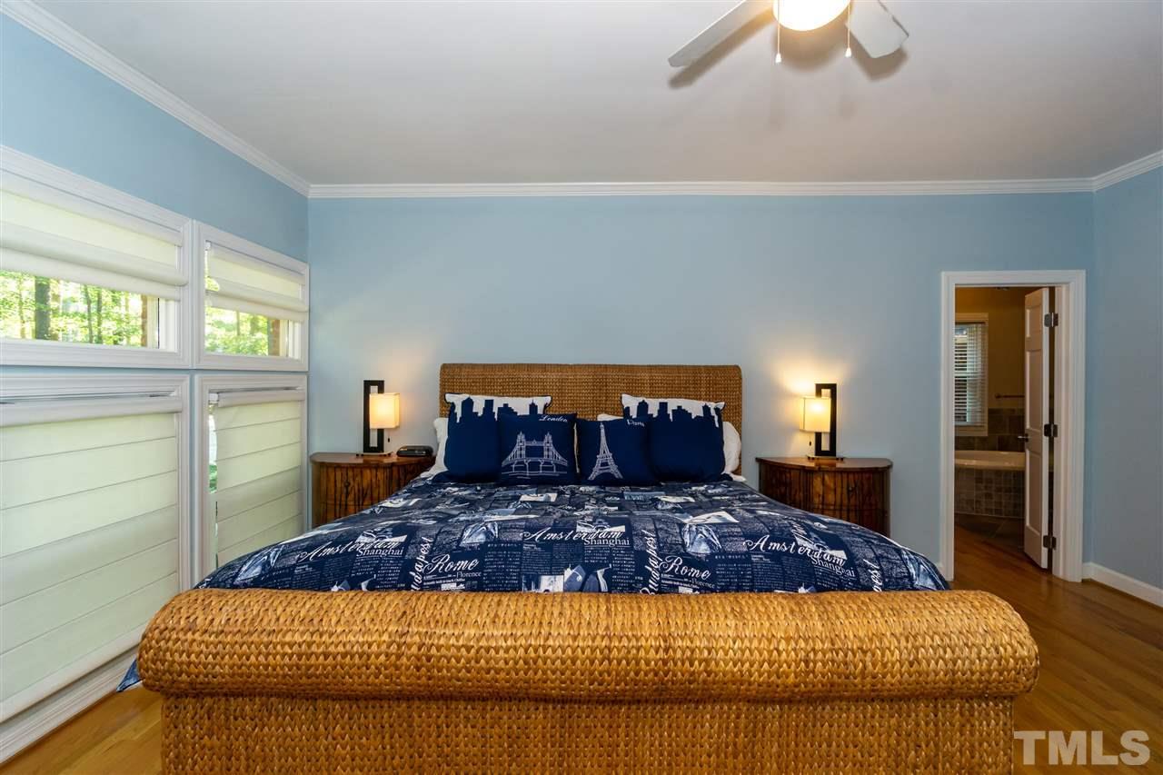 712 Misty Isle Place Raleigh, NC 27615 - Photo 17 of 30 a large bed sitting in a bedroom next to a window