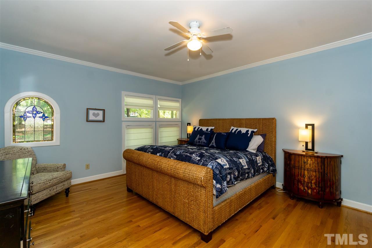 712 Misty Isle Place Raleigh, NC 27615 - Photo 18 of 30 a bedroom with a bed window and couch