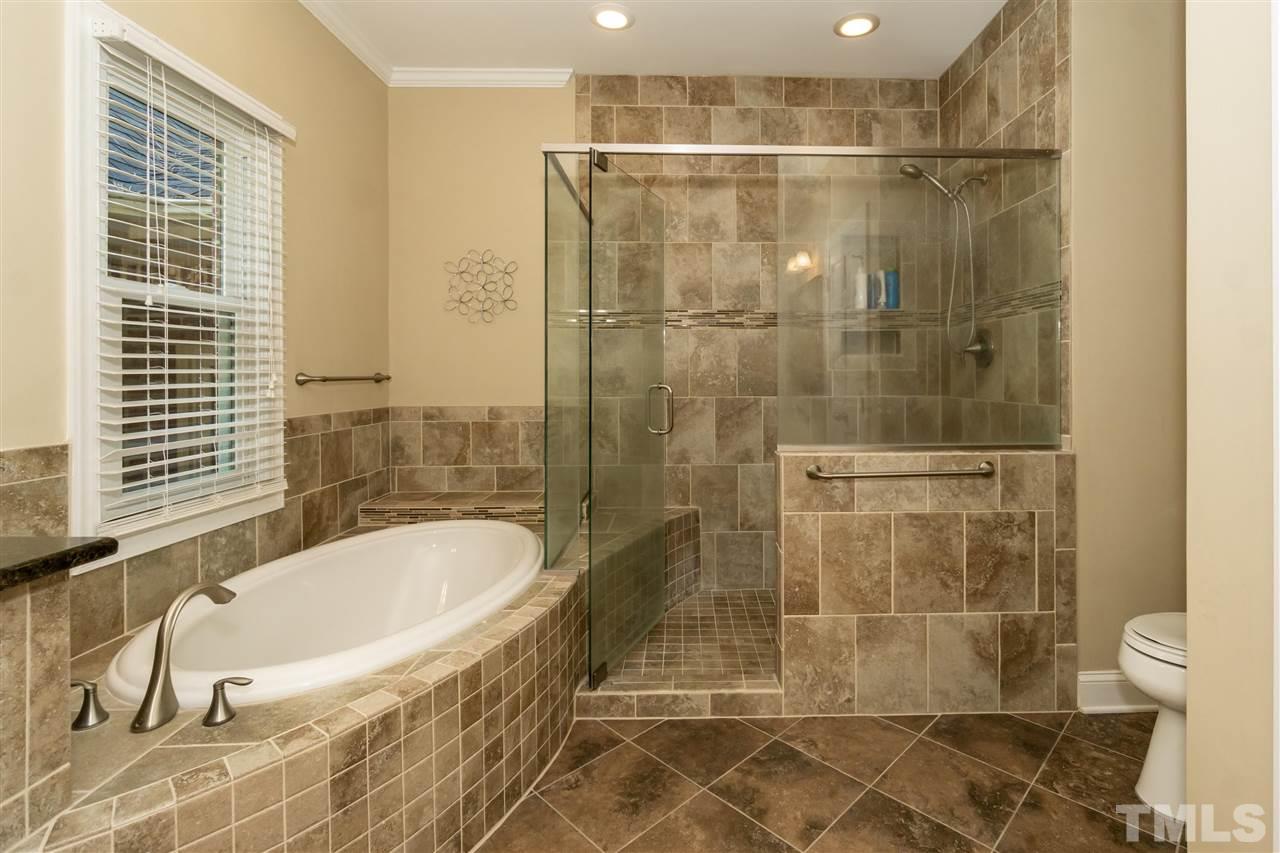 712 Misty Isle Place Raleigh, NC 27615 - Photo 19 of 30 a bathroom with a bathtub and a shower