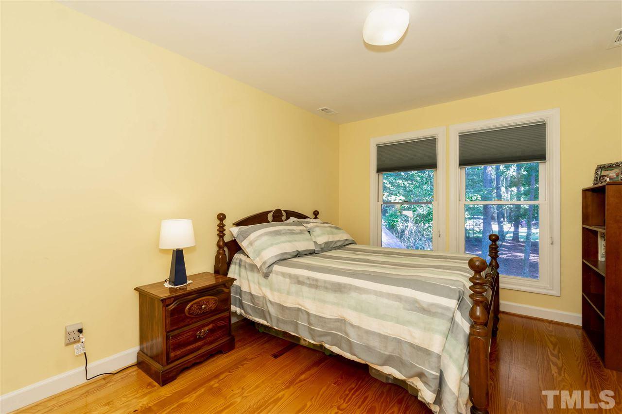 712 Misty Isle Place Raleigh, NC 27615 - Photo 22 of 30 a bedroom with a bed and a window