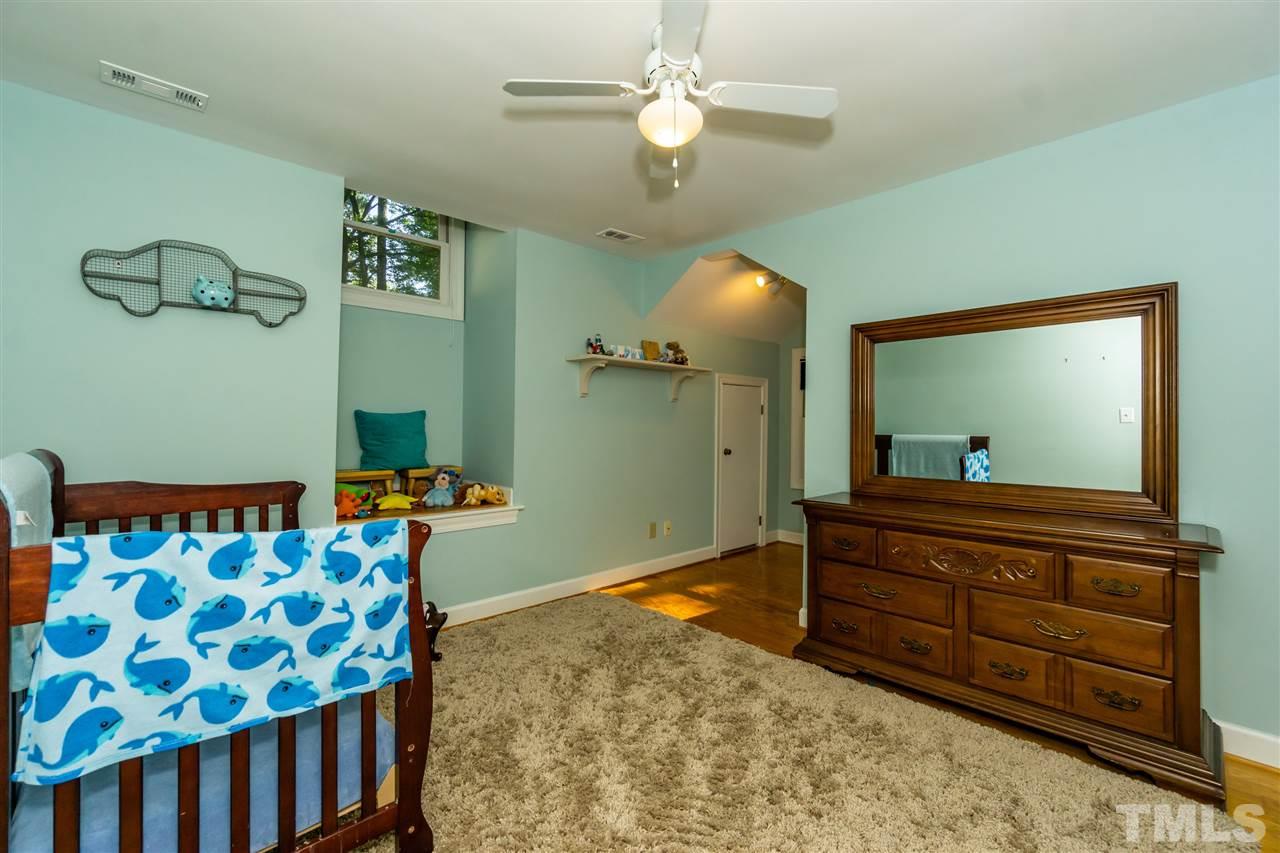 712 Misty Isle Place Raleigh, NC 27615 - Photo 23 of 30 a bedroom with a bed and a chandelier