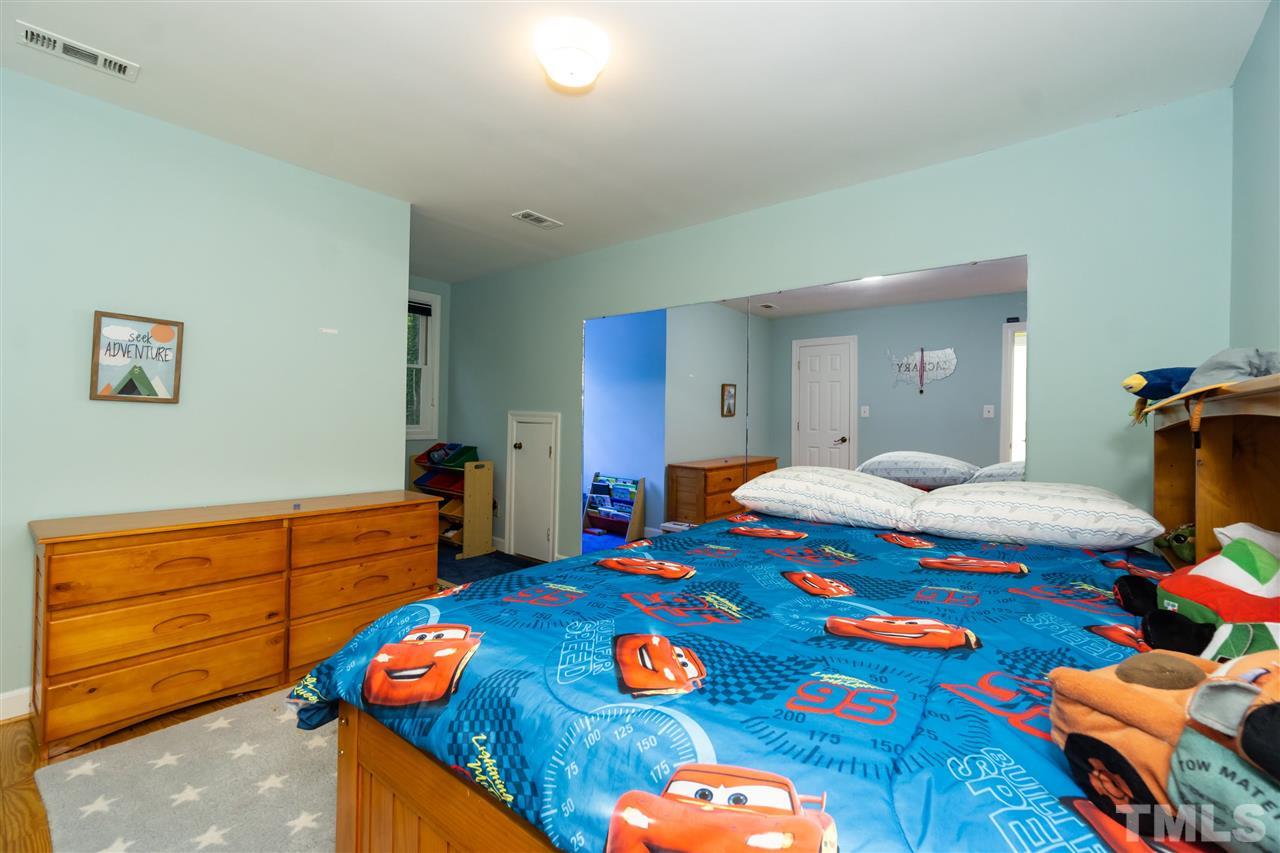 712 Misty Isle Place Raleigh, NC 27615 - Photo 24 of 30 a bedroom with furniture and a table