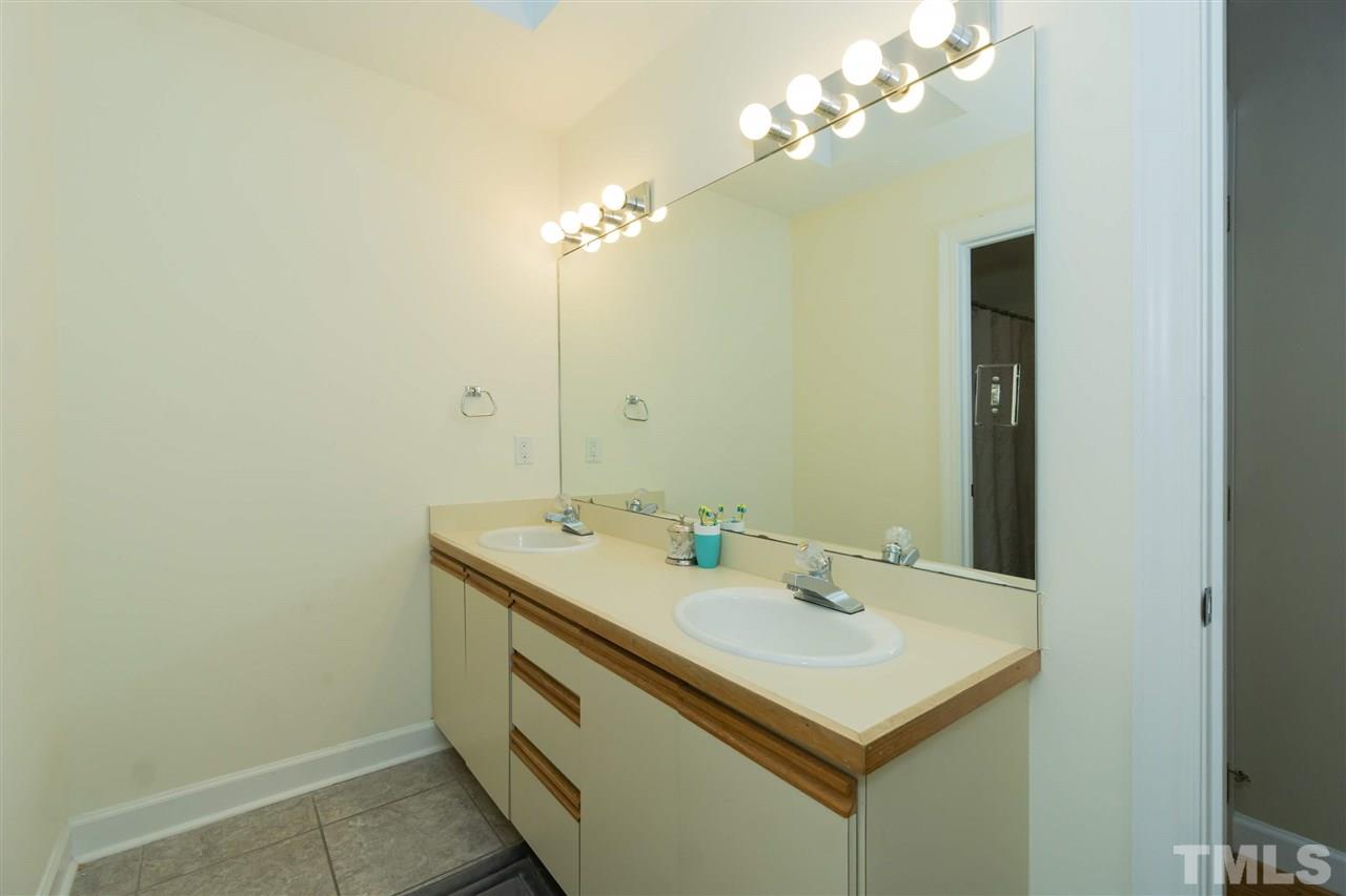 712 Misty Isle Place Raleigh, NC 27615 - Photo 25 of 30 a bathroom with a sink and a mirror