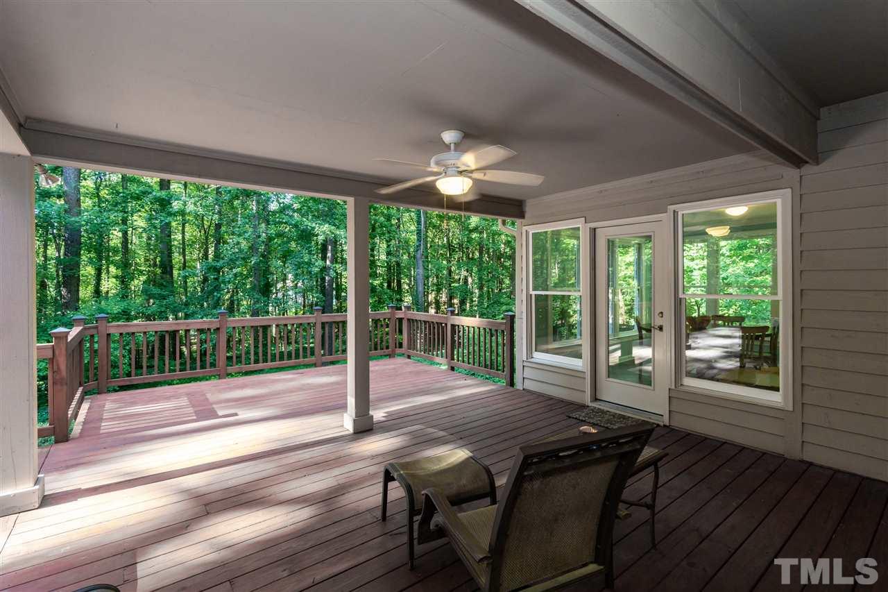 712 Misty Isle Place Raleigh, NC 27615 - Photo 26 of 30 a view of a patio with a table chairs and a backyard