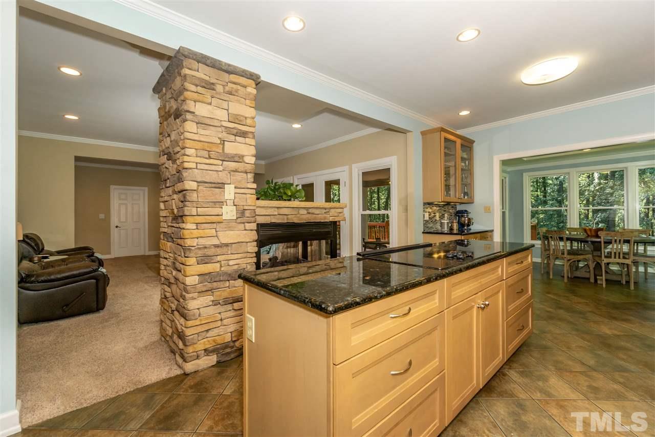 712 Misty Isle Place Raleigh, NC 27615 - Photo 8 of 30 a large kitchen with kitchen island a large counter top space and living room view