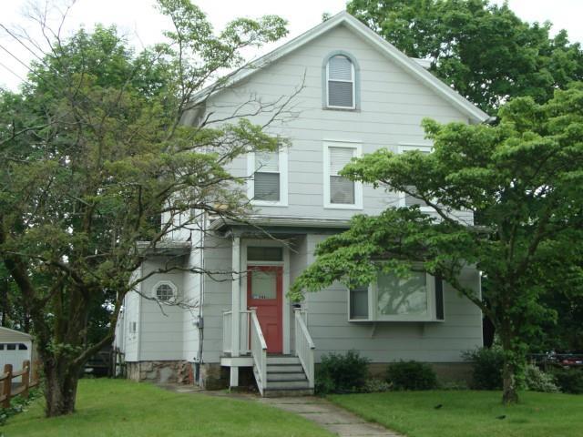46 1st Street, Unit 2 Norwalk, CT 06855 - Photo 1 of 1 a view of a white house next to a yard with big trees