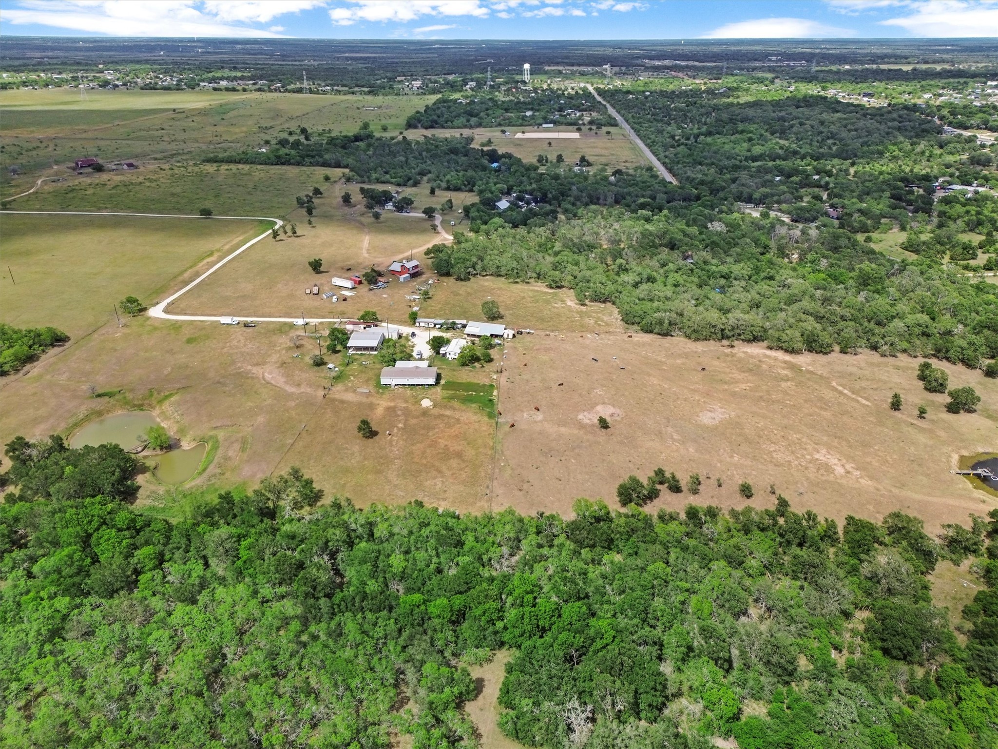 480 Grandpa Road Lockhart, TX 78644 - Photo 2 of 35 Tucked away on nearly 37 acres of peaceful Texas countryside, this one-of-a-kind property offers incredible versatility
with over $250,000 in improvements and four unique structures—making it the perfect canvas for a family compound,
creative retreat, or income-producing estate.