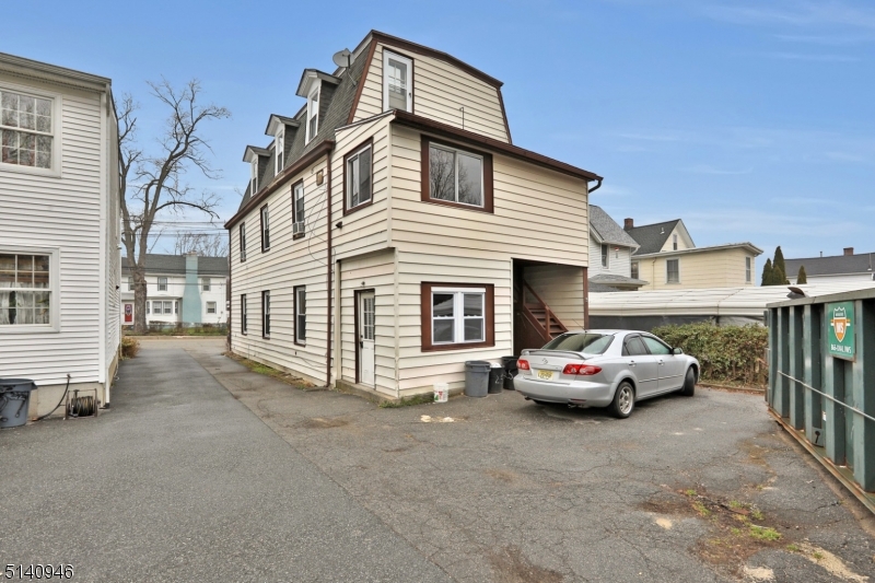 25 Kiel Avenue, Unit 1 Butler, NJ 07405 - Photo 13 of 13 a car parked in front of a house