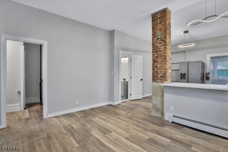 25 Kiel Avenue, Unit 1 Butler, NJ 07405 - Photo 4 of 13 wooden floor in an empty room with a window