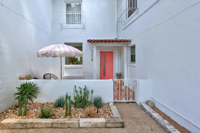 a front view of a house with potted plants