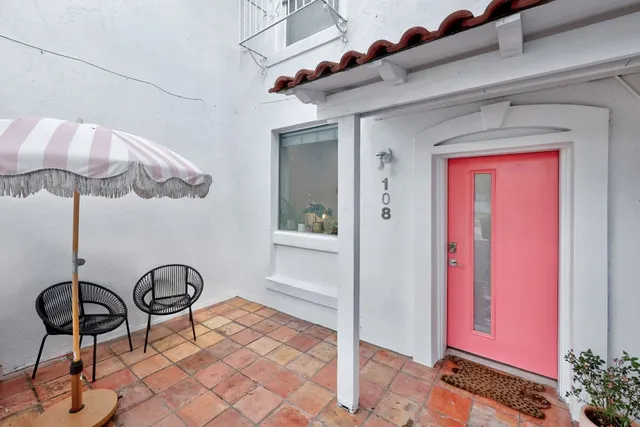 a view of a room with a table and chairs