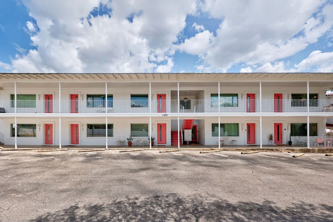1200 Enfield Road, Unit 107 Austin, TX 78703 - Photo 17 of 21 a front view of a residential apartment building with a yard