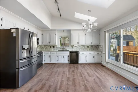 a view of a livingroom with a ceiling fan and window