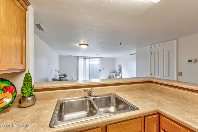 a kitchen with stainless steel appliances granite countertop a sink and a stove