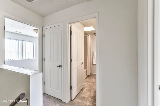 a en suite bathroom with a granite countertop tub sink and mirror