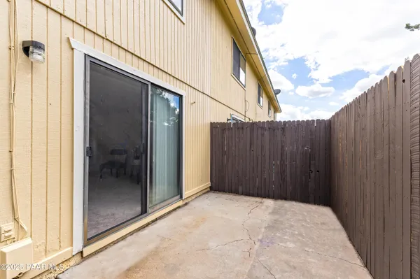 a view of backyard with tub and wooden fence