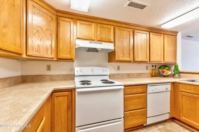 a kitchen with a sink a stove and cabinets