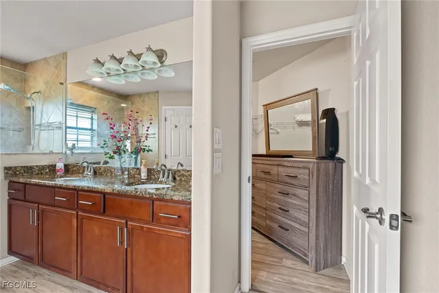 a bathroom with a sink vanity and a mirror