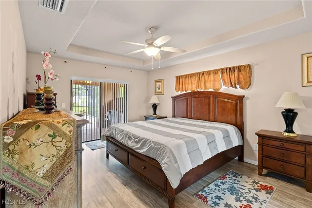 a bedroom with a large bed and a chandelier