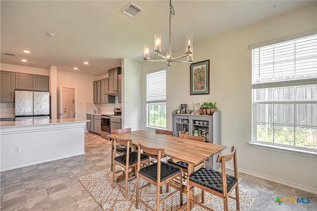 a dining room with furniture and window