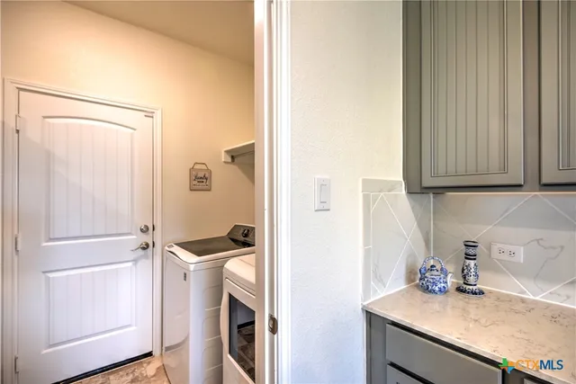 a view of a storage and utility room with a sink