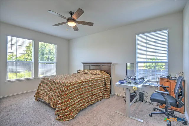 a bedroom with a bed a table and chair