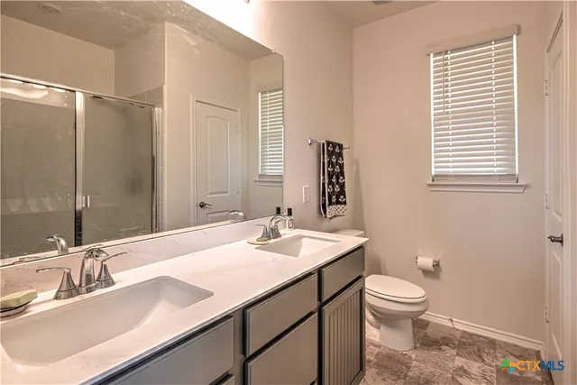 a bathroom with a sink toilet and shower
