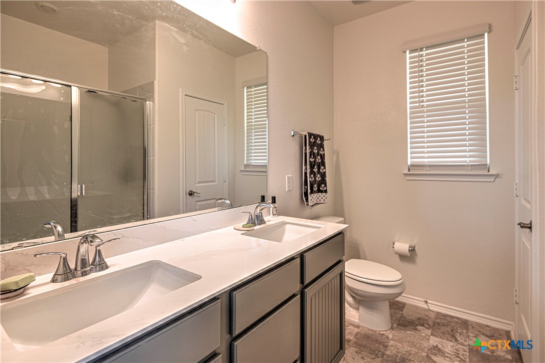 119 Lucky Texan Cove Jarrell, TX 76537 - Photo 22 of 33 a bathroom with a sink toilet and shower