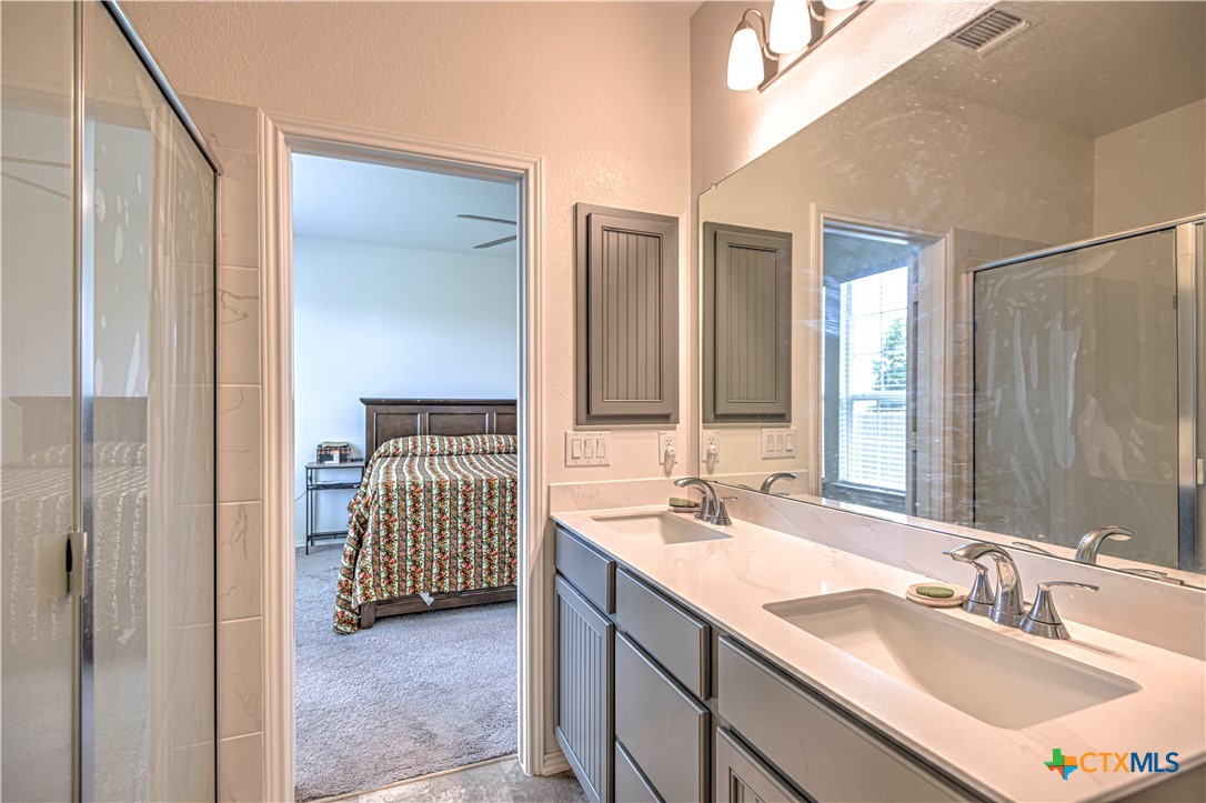 119 Lucky Texan Cove Jarrell, TX 76537 - Photo 23 of 33 a bathroom with a sink double vanity and a mirror