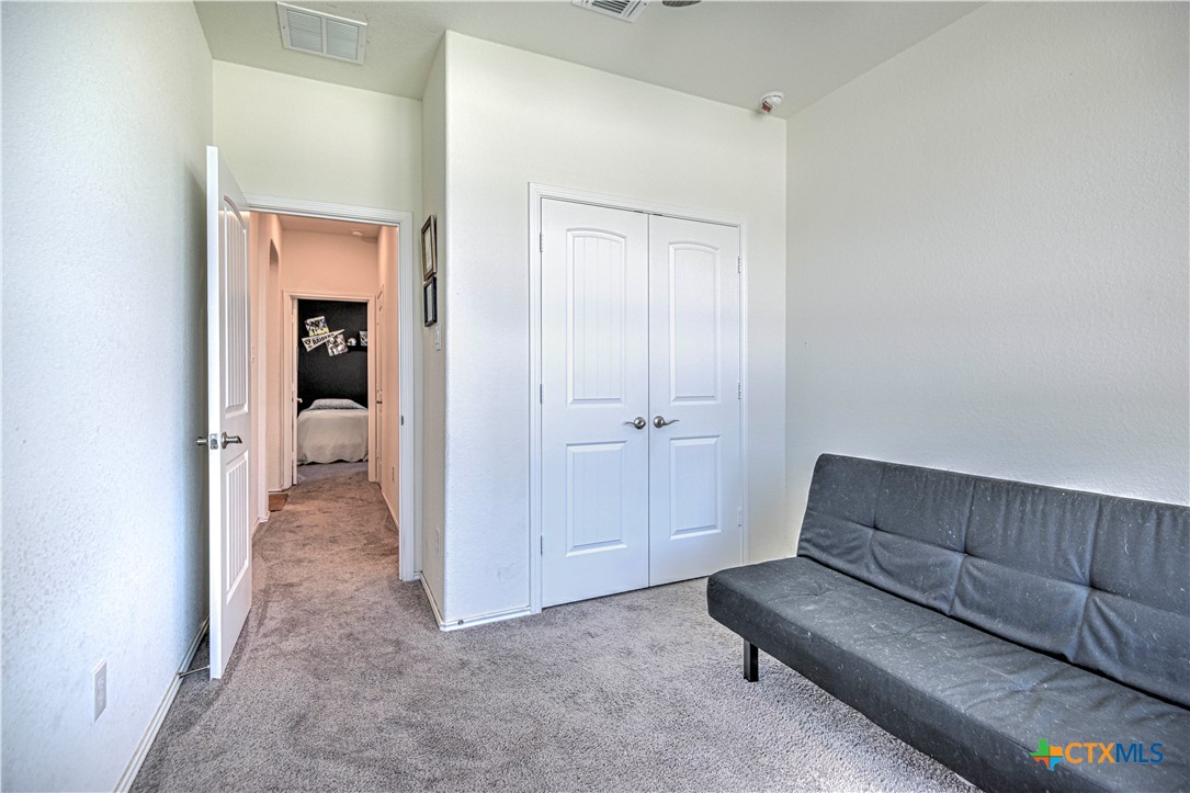 119 Lucky Texan Cove Jarrell, TX 76537 - Photo 25 of 33 a living room with furniture and a en suite bathroom