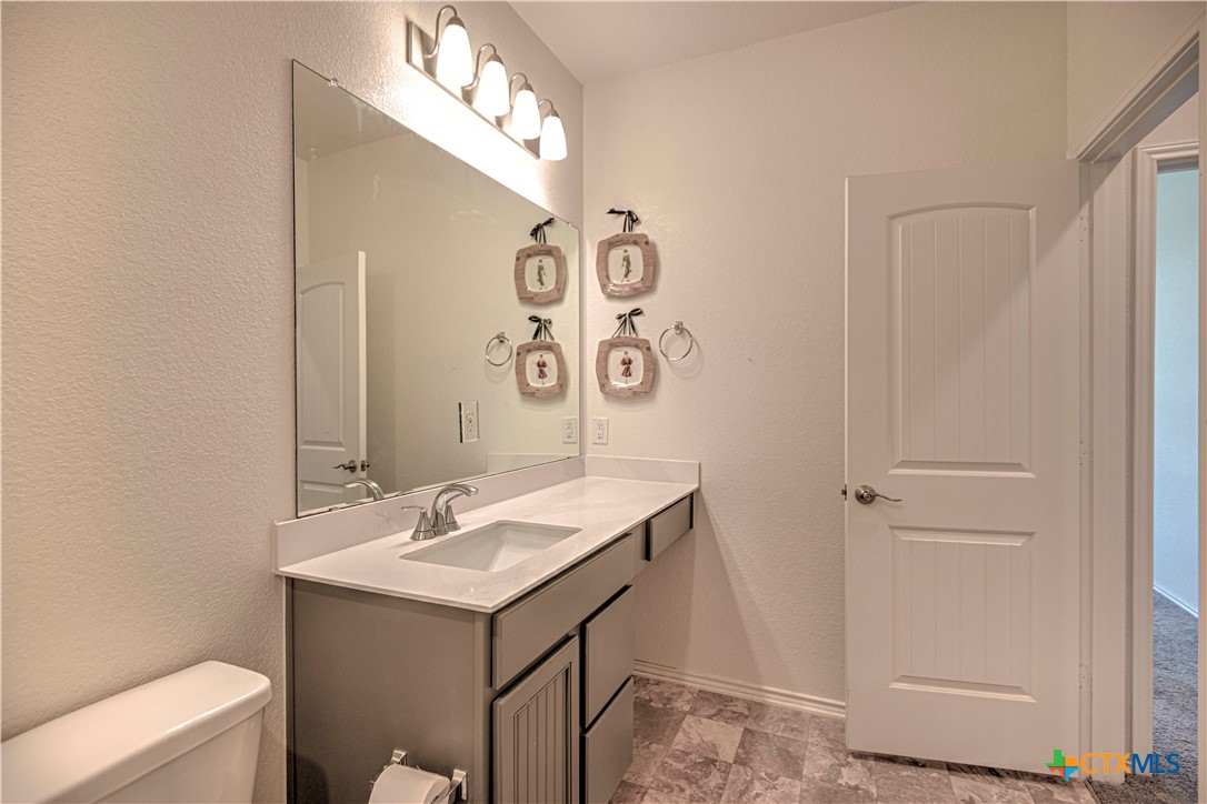 119 Lucky Texan Cove Jarrell, TX 76537 - Photo 28 of 33 a bathroom with a sink and a mirror