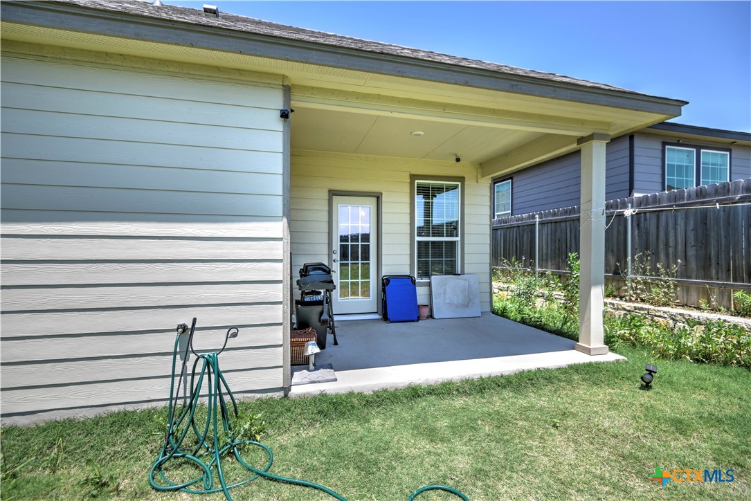 119 Lucky Texan Cove Jarrell, TX 76537 - Photo 33 of 33 a view of a chair and table in backyard of the house