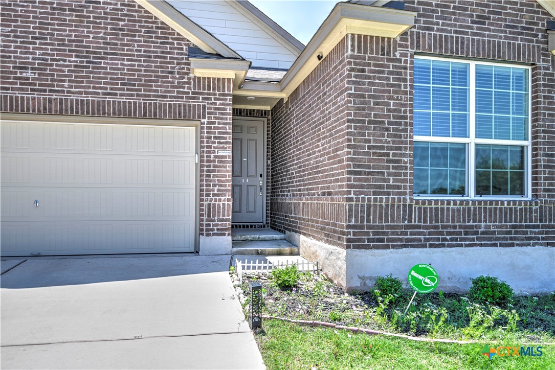 119 Lucky Texan Cove Jarrell, TX 76537 - Photo 5 of 33 a view of a brick house with a yard and potted plants