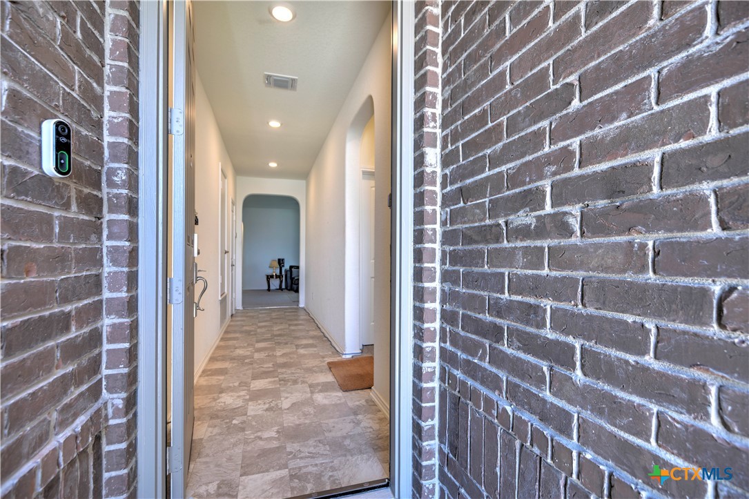 119 Lucky Texan Cove Jarrell, TX 76537 - Photo 6 of 33 a view of a hallway with a brick wall and a large window