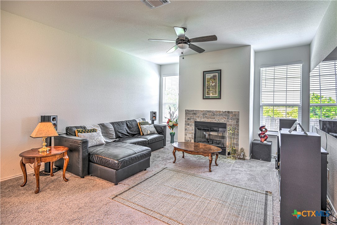 119 Lucky Texan Cove Jarrell, TX 76537 - Photo 7 of 33 a living room with furniture and a fireplace