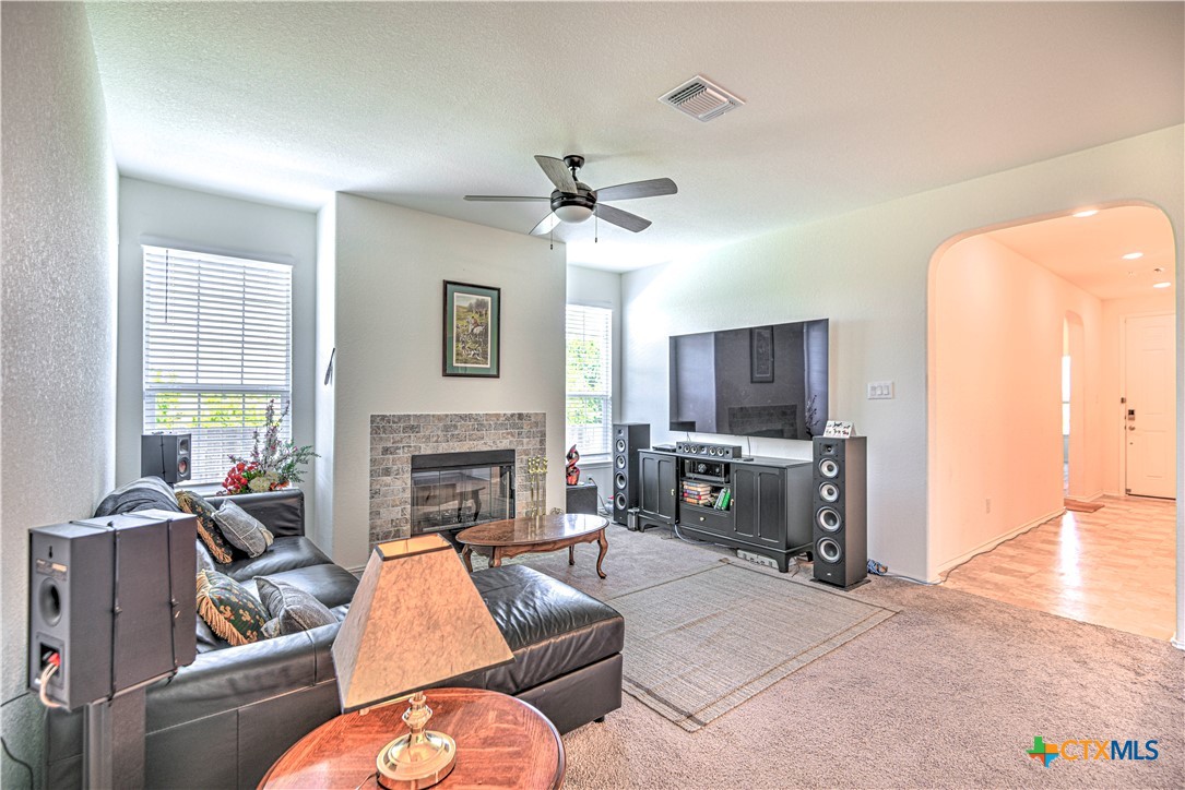 119 Lucky Texan Cove Jarrell, TX 76537 - Photo 8 of 33 a living room with furniture a fireplace and a flat screen tv