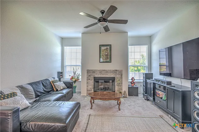 a living room with furniture and a fireplace