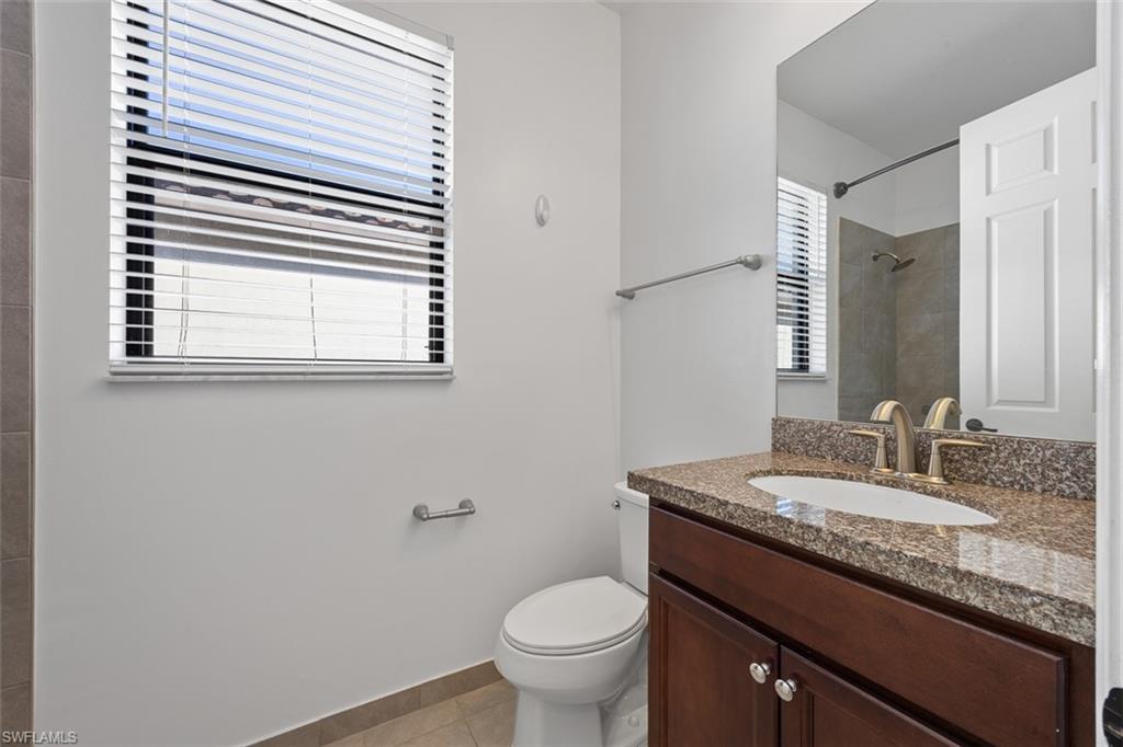 5538 Useppa Drive Ave Maria, FL 34142 - Photo 10 of 35 a bathroom with a granite countertop toilet a sink and a mirror