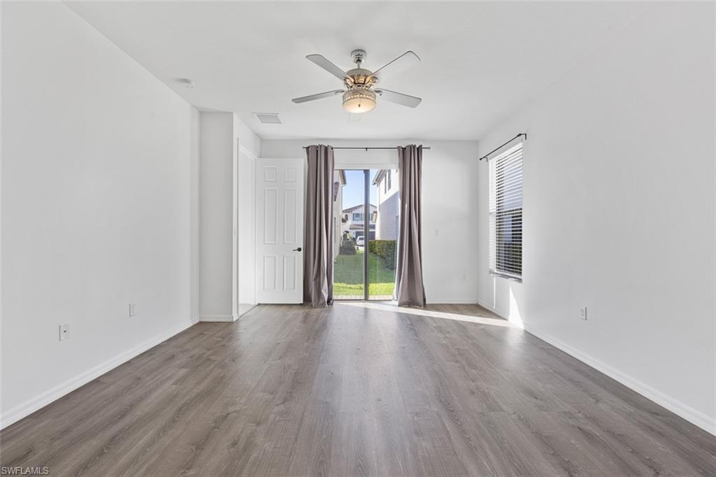 5538 Useppa Drive Ave Maria, FL 34142 - Photo 22 of 35 an empty room with wooden floor chandelier and windows