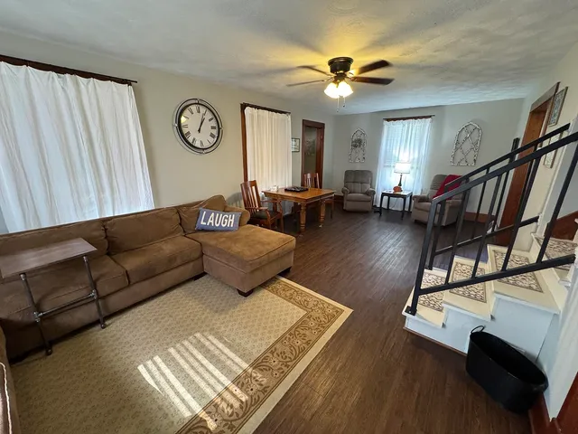 a living room with furniture and a clock