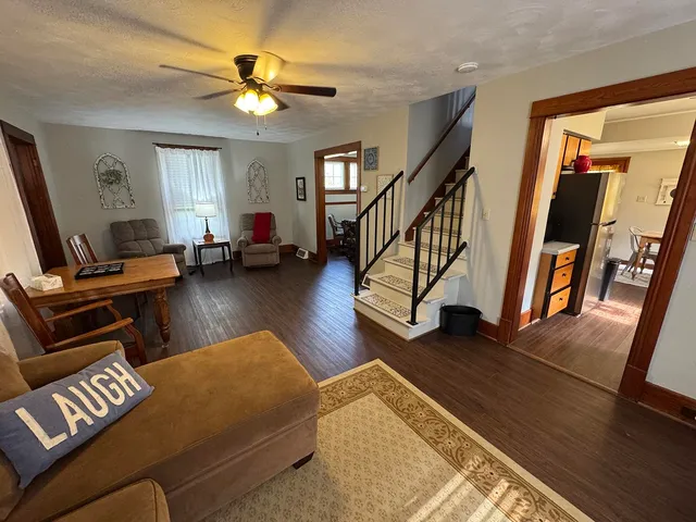 a living room with furniture and a chandelier