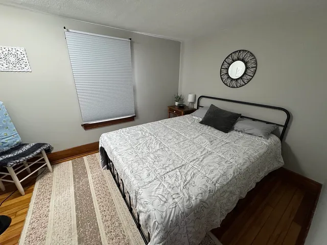 a bedroom with a bed and a mirror