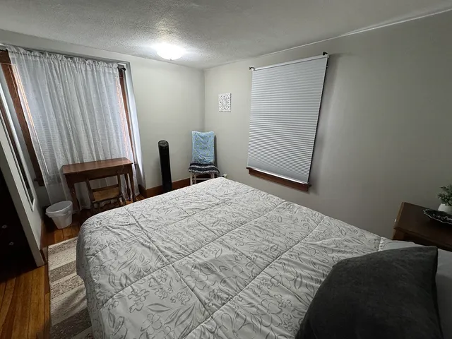 a bedroom with a bed and a chair