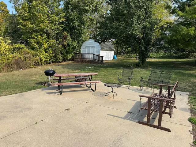 a swimming pool with outdoor seating and yard