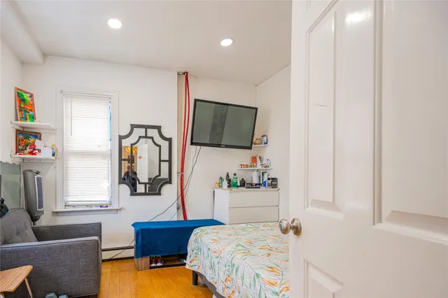 a bedroom with a bed and a flat screen tv