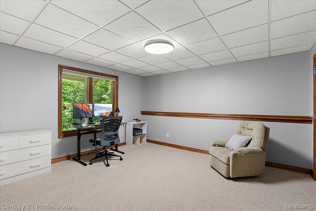 9867 Rainbow Ridge Drive Schoolcraft, MI 49087 - Photo 52 of 82 Carpeted room featuring a large window with natural wood trim, light gray walls with a chair rail, and a grid ceiling