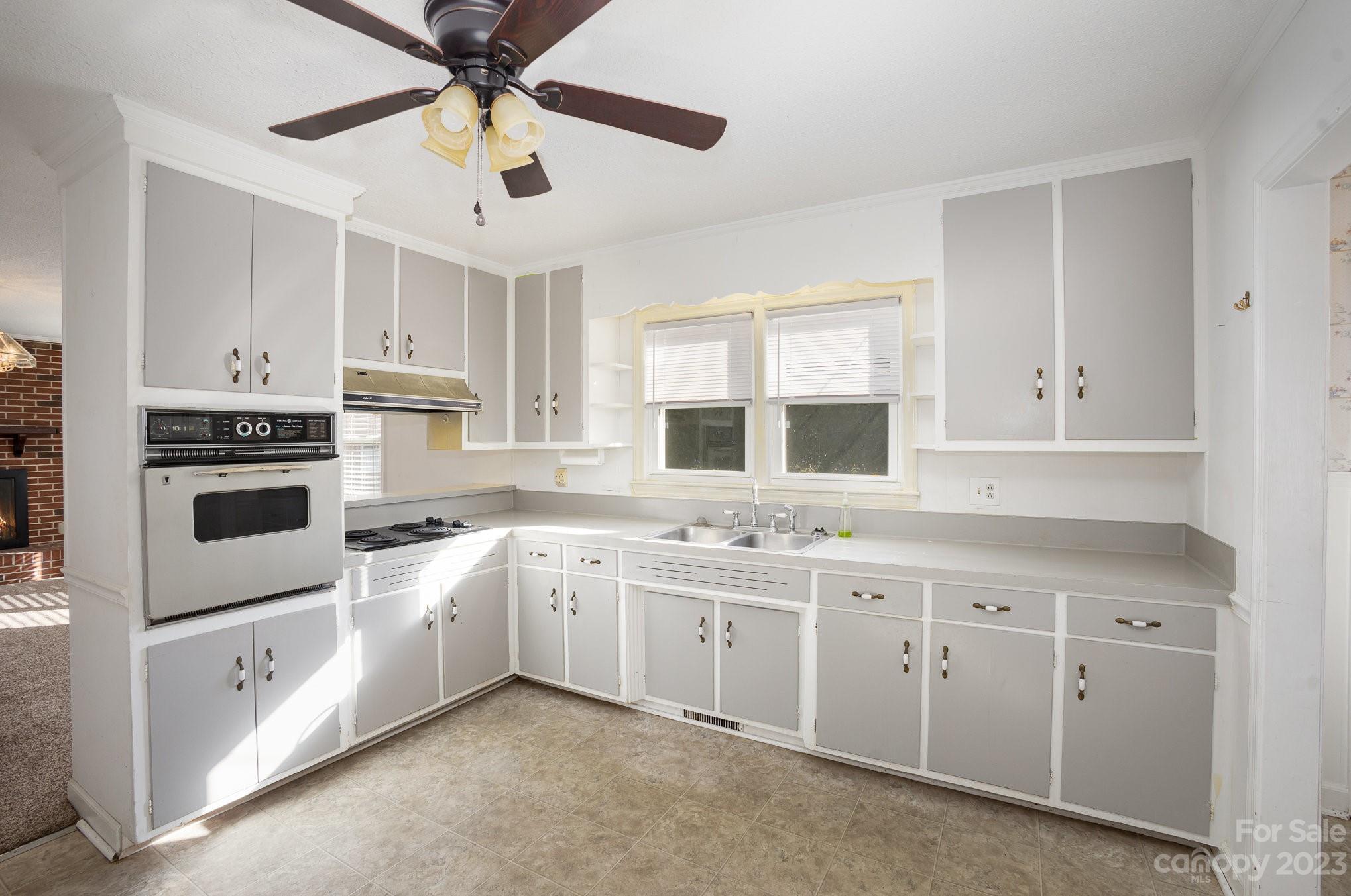 408 Jane Street Cherryville, NC 28021 - Photo 3 of 15 a kitchen with white cabinets and white appliances
